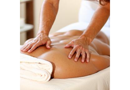 Hands performing therapeutic massage on a relaxed client